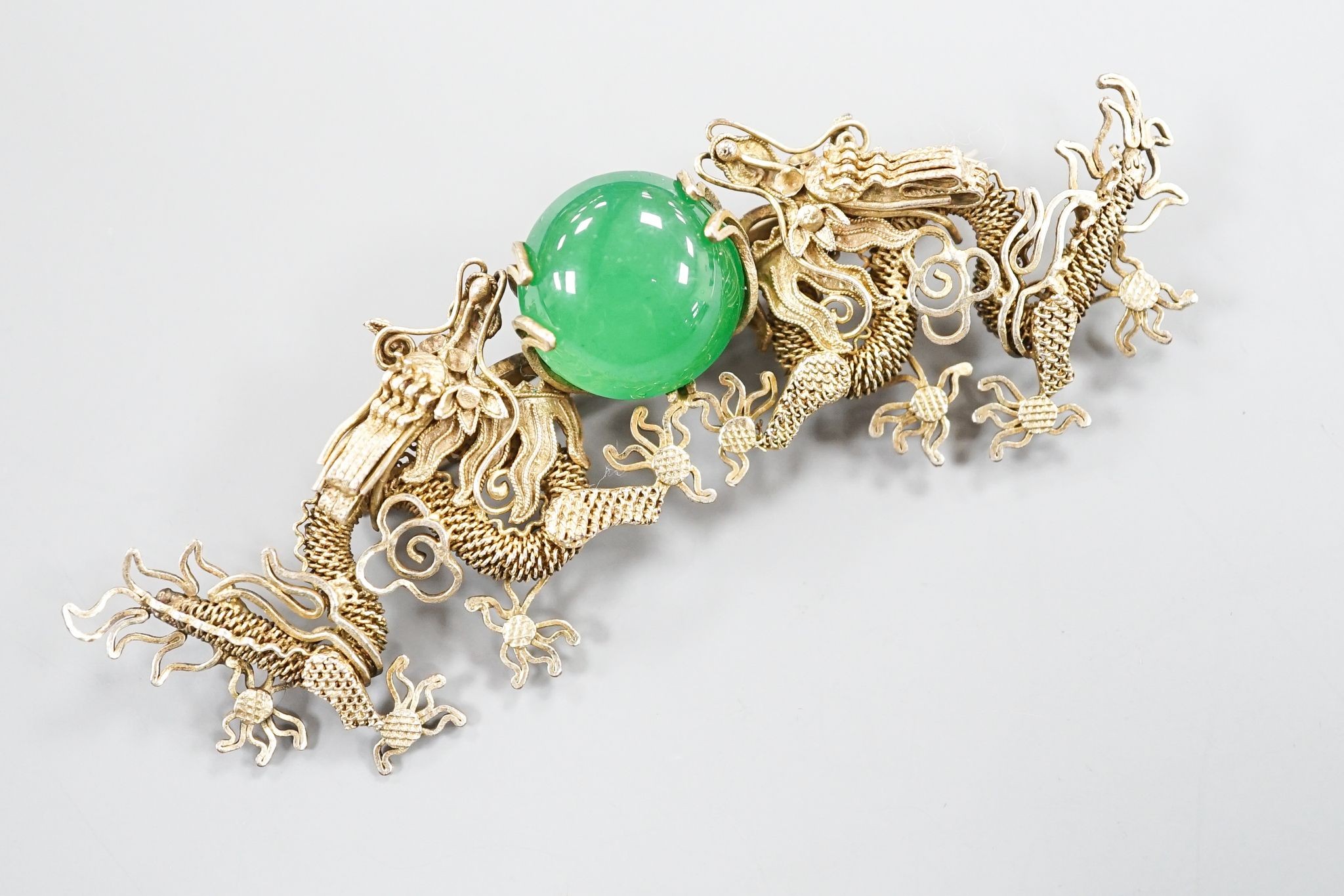 A Chinese gilt white metal and green cabochon set dragon brooch, 89mm.